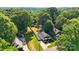 An aerial view showing a home with a fenced backyard and lush, mature trees surrounding the property at 840 10Th Street Nw Blvd, Hickory, NC 28601