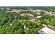 Aerial view featuring a home nestled within lush trees near commercial areas, marked with an arrow for easy identification at 840 10Th Street Nw Blvd, Hickory, NC 28601