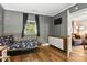 A bedroom featuring hardwood floors, a window, a dresser, and access to the living room at 840 10Th Street Nw Blvd, Hickory, NC 28601