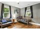 Bedroom featuring wood floors, two windows, a seating area, and a bed at 840 10Th Street Nw Blvd, Hickory, NC 28601