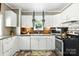 Bright kitchen showcasing white cabinets, granite countertops, and modern appliances at 840 10Th Street Nw Blvd, Hickory, NC 28601