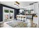 Modern kitchen with white cabinets, island with seating, and sliding door to outdoor patio at 840 10Th Street Nw Blvd, Hickory, NC 28601