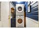 Laundry room includes stacked washer and dryer with wooden wall paneling at 840 10Th Street Nw Blvd, Hickory, NC 28601