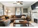 Cozy living room with a brown sectional sofa, fireplace, and a ceiling fan at 840 10Th Street Nw Blvd, Hickory, NC 28601