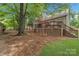 Spacious backyard featuring a large deck, lush lawn and mature trees at 9040 Scottsboro Dr, Huntersville, NC 28078