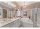 Bright bathroom with a soaking tub, double vanity, and plenty of counter space at 9040 Scottsboro Dr, Huntersville, NC 28078