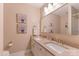 Bright and airy bathroom featuring a double sink vanity, gold fixtures, and wall art at 9040 Scottsboro Dr, Huntersville, NC 28078