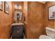 Stylish half bathroom with elegant vanity, textured walls, and modern fixtures at 9040 Scottsboro Dr, Huntersville, NC 28078