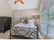 Bedroom features high ceilings, many windows, and an elegant metal bed frame at 9040 Scottsboro Dr, Huntersville, NC 28078