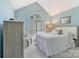 Cozy bedroom with vaulted ceiling, large window, and neutral décor at 9040 Scottsboro Dr, Huntersville, NC 28078