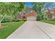 Traditional brick home with a well-manicured front yard, long driveway, and a basketball hoop, perfect for outdoor activities at 9040 Scottsboro Dr, Huntersville, NC 28078