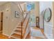 Welcoming two-story foyer with hardwood floors, staircase, and large window offering lots of light at 9040 Scottsboro Dr, Huntersville, NC 28078