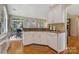 Charming kitchen with white cabinetry, granite countertops, and hardwood floors, blending style and functionality at 9040 Scottsboro Dr, Huntersville, NC 28078