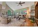 Bright living room featuring a vaulted ceiling, hardwood floors, a fireplace, and lots of natural light from large windows at 9040 Scottsboro Dr, Huntersville, NC 28078