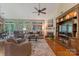 Well-lit living room featuring hardwood floors, a fireplace, built-in shelving, and many windows at 9040 Scottsboro Dr, Huntersville, NC 28078