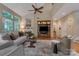 Open living room with hardwood floors, a fireplace, built-in shelves, and large windows, offering plenty of natural light at 9040 Scottsboro Dr, Huntersville, NC 28078