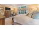 Bright main bedroom showcases an expansive bed, a desk, and multiple windows at 9040 Scottsboro Dr, Huntersville, NC 28078