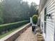 Beautiful backyard with a well-manicured hedge, brick patio, and lush landscaping at 919 Lily Magnolia Ct, Fort Mill, SC 29707