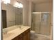 Bright bathroom features a double vanity, and glass-enclosed shower at 919 Lily Magnolia Ct, Fort Mill, SC 29707