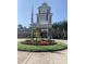 Welcoming entrance to Sun City Carolina Lakes with manicured flower beds at 919 Lily Magnolia Ct, Fort Mill, SC 29707