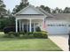 Charming single-story home featuring a well-manicured lawn and inviting covered front porch at 919 Lily Magnolia Ct, Fort Mill, SC 29707