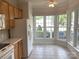 Bright breakfast area featuring light wood cabinets, stainless steel appliances, and many windows at 919 Lily Magnolia Ct, Fort Mill, SC 29707