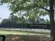 Sun City Carolina Lakes Tennis Courts featuring well-maintained courts surrounded by lush greenery and mature trees at 919 Lily Magnolia Ct, Fort Mill, SC 29707