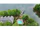 Aerial view of lake complex featuring a swimming pool and boat docks with mature trees at 921 Northeast Dr, Davidson, NC 28036