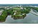 Aerial view of complex surrounded by trees and lake with bridge and boat dock at 921 Northeast Dr, Davidson, NC 28036