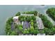 Aerial view of a complex with parking and mature trees near the lake at 921 Northeast Dr, Davidson, NC 28036