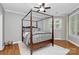 A luxurious bedroom featuring a four-poster bed, natural lighting, and hardwood floors at 921 Northeast Dr, Davidson, NC 28036