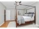 A luxurious bedroom featuring a four-poster bed, natural lighting, and hardwood floors at 921 Northeast Dr, Davidson, NC 28036