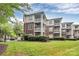 Inviting exterior of brick and siding condo building with well-manicured lawn and lush greenery at 921 Northeast Dr, Davidson, NC 28036