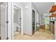 Open hallway showcasing neutral tones, tile flooring, and access to a modern bathroom at 921 Northeast Dr, Davidson, NC 28036