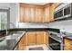 Bright kitchen featuring granite countertops, tile backsplash, stainless appliances, and wood cabinetry at 921 Northeast Dr, Davidson, NC 28036