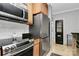 Well-lit kitchen featuring stainless steel appliances, a pantry, and tile flooring at 921 Northeast Dr, Davidson, NC 28036