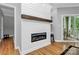 Bright living room with shiplap accent wall with fireplace and access to the outdoor balcony at 921 Northeast Dr, Davidson, NC 28036