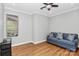 Well-lit living room features a ceiling fan, hardwood floors, and a comfortable blue couch at 921 Northeast Dr, Davidson, NC 28036