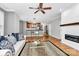 Open concept living room with fireplace, wood floors, and access to the kitchen at 921 Northeast Dr, Davidson, NC 28036