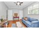 Cozy living room with hardwood floors, a ceiling fan, and a comfortable blue couch at 921 Northeast Dr, Davidson, NC 28036