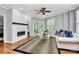 Living room boasts hardwood floors, fireplace, and sliding glass doors to the outdoor deck at 921 Northeast Dr, Davidson, NC 28036