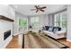 Living room boasts hardwood floors, fireplace, and sliding glass doors to the outdoor deck at 921 Northeast Dr, Davidson, NC 28036