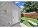Backyard with artificial grass and a newly painted back door at 10078 Pergola View Ct, Charlotte, NC 28213
