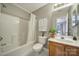 Cozy bathroom featuring a shower/tub combo, wooden vanity, and neutral color scheme at 10078 Pergola View Ct, Charlotte, NC 28213
