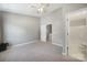 This airy bedroom boasts neutral carpeting and paint, and a ceiling fan light fixture at 10078 Pergola View Ct, Charlotte, NC 28213