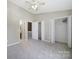 Well-lit bedroom with plush carpeting, multiple closets, and access to the en-suite bathroom at 10078 Pergola View Ct, Charlotte, NC 28213