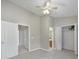 Bedroom showcasing plush carpet, neutral walls, closets, ceiling fan, and bathroom access at 10078 Pergola View Ct, Charlotte, NC 28213
