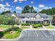 Well-maintained townhome with manicured landscaping, parking, and appealing architectural details under a blue sky at 10078 Pergola View Ct, Charlotte, NC 28213