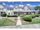 Charming townhome featuring a brick facade, manicured landscaping, and a welcoming front porch at 10078 Pergola View Ct, Charlotte, NC 28213