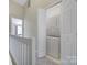 Convenient upper-level laundry area with a stacked washer and dryer unit at 10078 Pergola View Ct, Charlotte, NC 28213